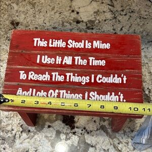 Red Wooden Stool with White Text